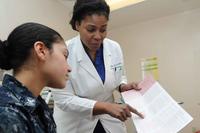 An obstetrician confers with a female patient.